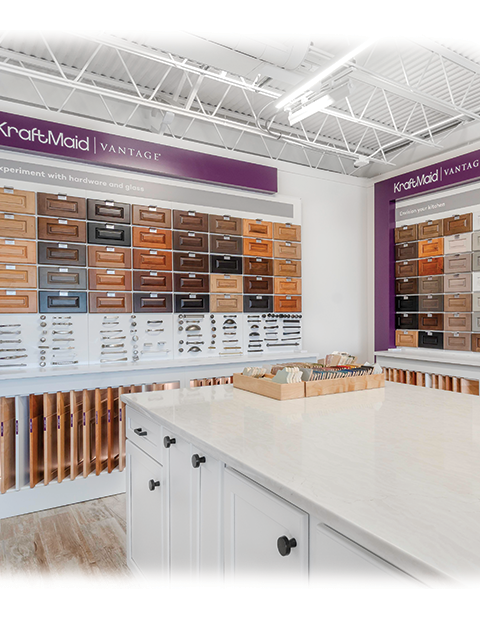 Custom white kitchen cabinets with various hardware samples and countertop options in a showroom – Aransas Pass display.
