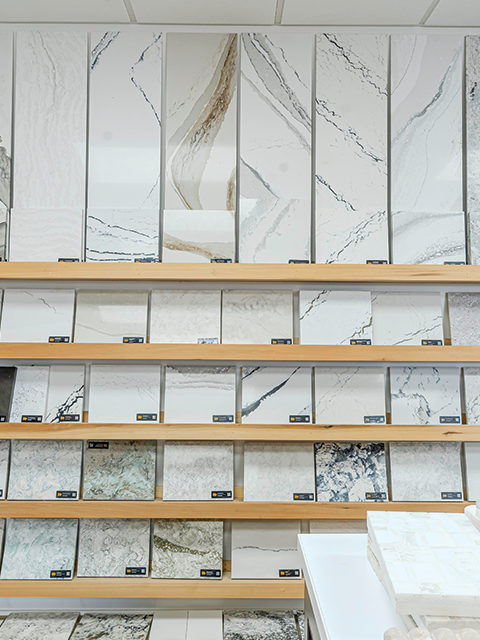 Display of various quartz and marble countertop samples in a showroom – 361 Cabinets, Aransas Pass.